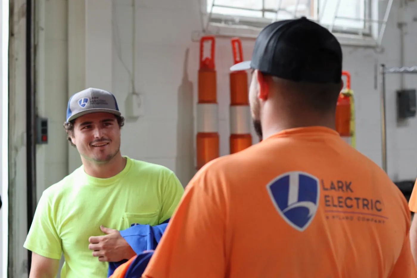 Lark Electric crew members talking in the shop